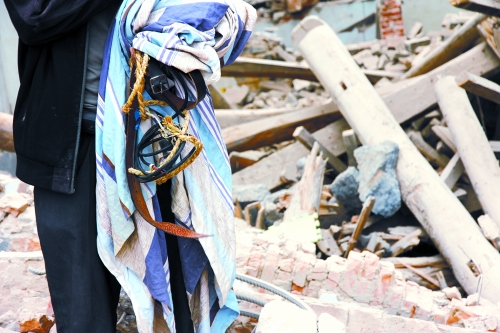 老人手中拿著曾控制住他的電線、床單