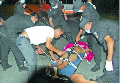 眾人合力將狂犬病發(fā)作的江某控制住。 孫東城 攝