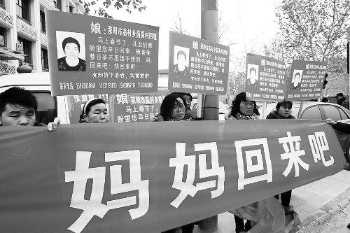 張慧媛老人的子女們舉著尋找母親的牌子和橫幅，在冷風中呼喊著“媽媽，您快回來吧”。